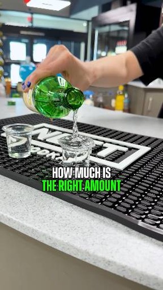 A bottle being poured into a tasting glass at Liquor Loft